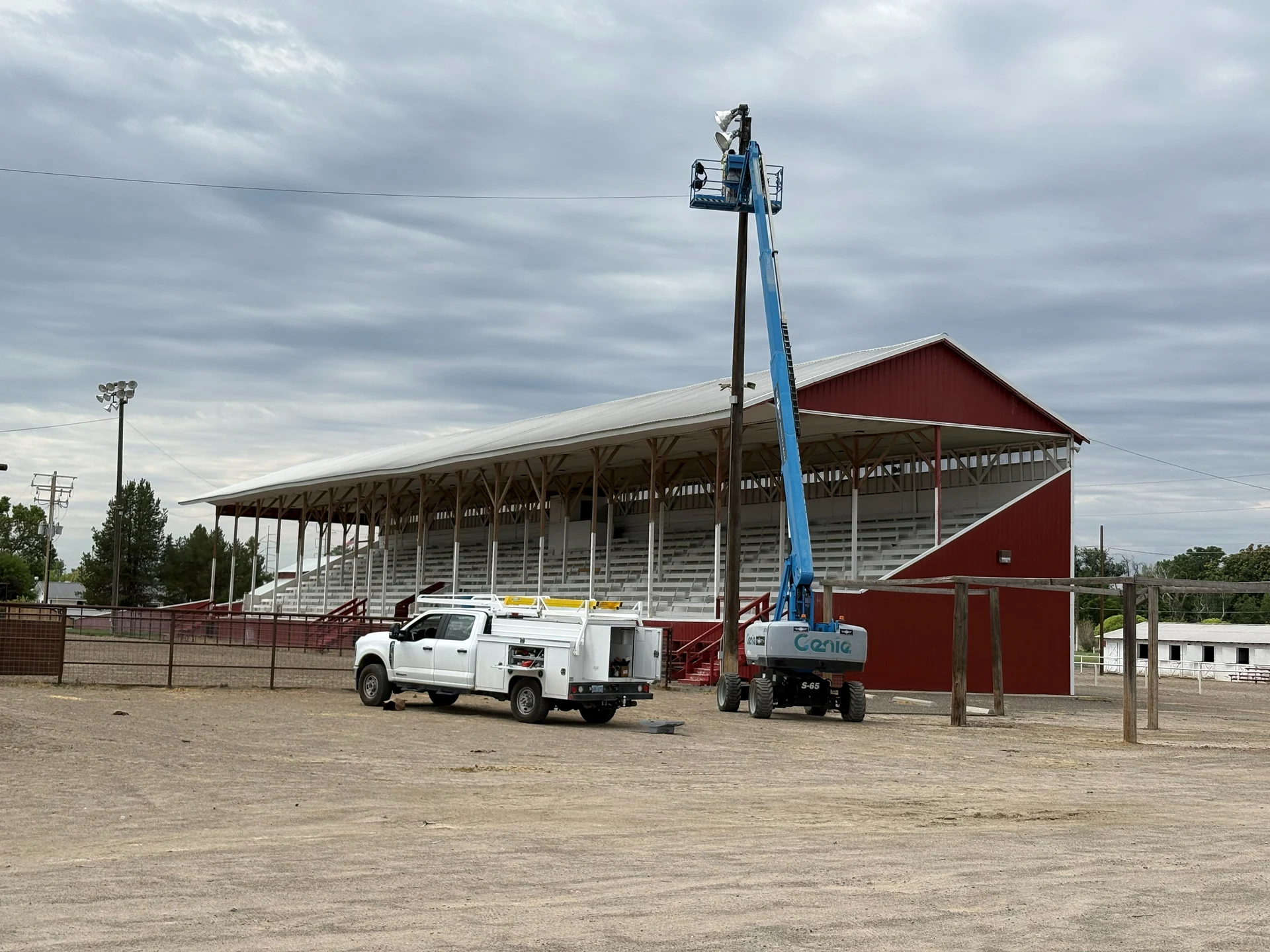 Commercial stadium lighting service call with boom lift and utility truck in Ontario, OR by Campbell Electric