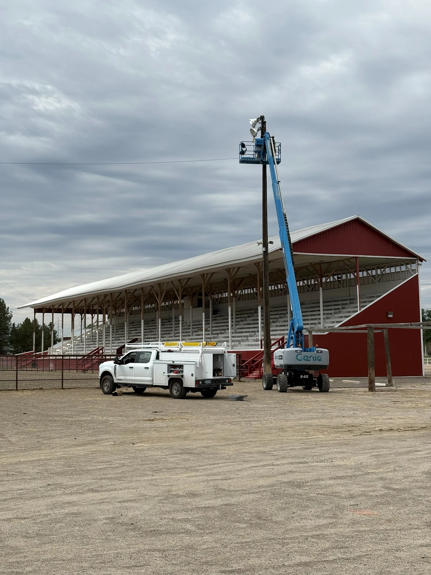 Public works stadium lighting repair with boom lift at outdoor grandstand in Ontario, OR by Campbell Electric